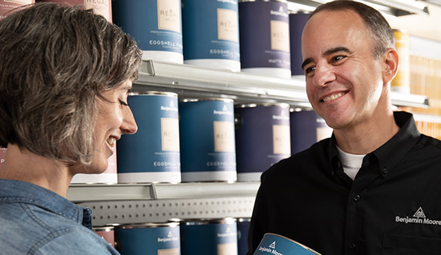 A Benjamin Moore retailer helps a homeowner find the right product for her project. A Benjamin Moore retailer helps a homeowner find the right product for her project.