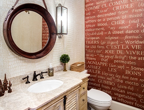 A beautiful bathroom with a bold red accent wall with the Cajun dictionary stenciled on top. A beautiful bathroom with a bold red accent wall with the Cajun dictionary stenciled on top.
