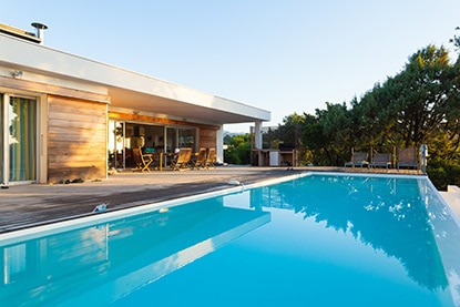 Outdoor pool with surrounding wooden decking Outdoor pool with surrounding wooden decking