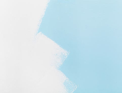 A blue wall in the process of being painted white. A blue wall in the process of being painted white.