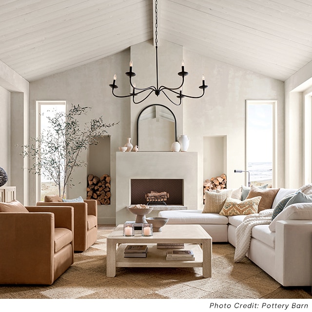 An off-white living space with shiplap walls and neutral furniture. An off-white living space with shiplap walls and neutral furniture.