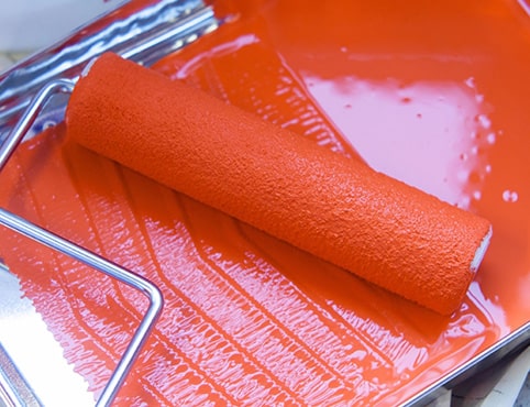 Paint in a tray with a loaded roller Paint in a tray with a loaded roller