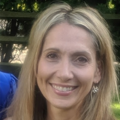 A head shot of a Caucasian woman with dirty blonde hair.